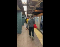 Guy walks with dog standing on shoulders 