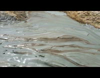 Sloshy mudflow flow down sound from volcano