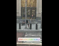 Woman blue glossy bikini lamppost sidewalk  pictorial