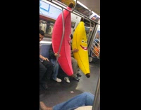Huge pink and yellow banana plushies in train