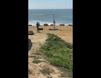 woman white dress spin pole beach