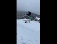 Guy sleds down hill and lands