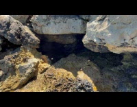 Seawater Flows Through Weathered Rock by Beach
