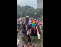 Man garbage on head walks in fountain