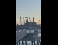 Man hangs on the lamppost while plane flew by