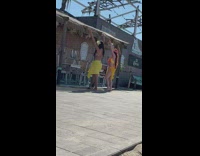 2 hula dancers perform for video in yellow 