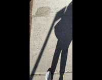 Guy sleeps on red chair on sidewalk 