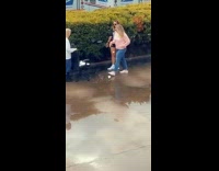 Black shirt girl holds dog wearing sunglasses 