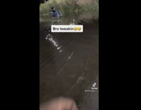 Guy in shopping cart in middle of flooded parking lot 