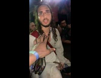 Guy in jesus outfit gives guy fist bump 