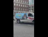White vans drive and honk celebrating a rabbi 