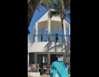 Girl dances on balcony while dad films