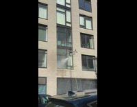 Drone power washing a window