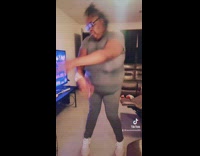 Chubby woman dances in grey leotard 
