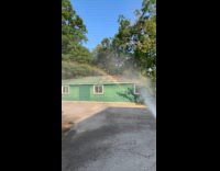 Man makes rainbow using pressure washer