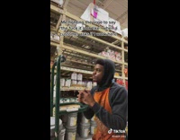 Guy in orange home depot apron with hands together on green pulley