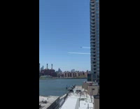 guy films across river planes over ciity