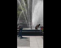 man takes shower under fountain