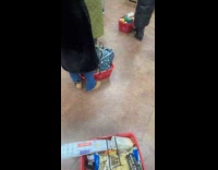 People pushing basket with foot in line