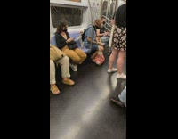 Man has white dog strapped to back