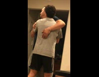 Guy hugging dad in kitchen asking for forgiveness choke