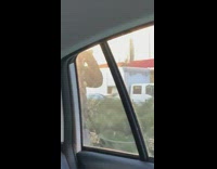 Guy runs sidewalk with cone on head