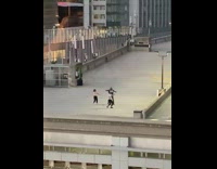 Three people dance together rooftop garage 