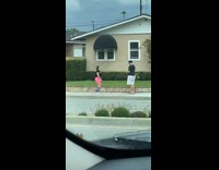 Neon pink shorts girl dances sidewalk neighborhood  