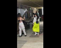 Green skirt girl poses hand drying fan 