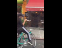 White pants guy kneels red heart street 