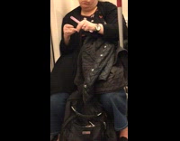 Woman files her nails down on the subway train