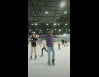 Guy ice skates almost loses his balance