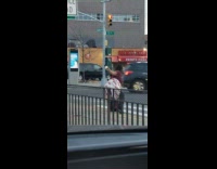 Red shirt girl dances on sidewalk car 