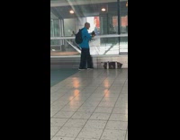 Guy blue shirt yells out loud to himself at ferry station duffel bag