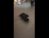 Guy cries on sidewalk floor 