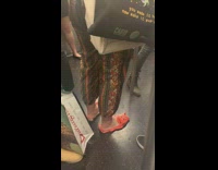 Woman wears orange plastic fish slippers on the subway #BluePointWhatTheL