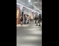 Woman black dress poses on rug for picture