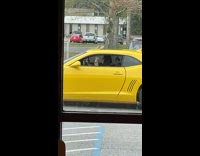 Woman takes picture of her coffee inside her car