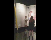 Girl poses in front of book prop