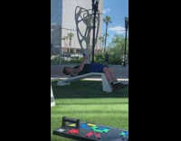 Guy holds phone sit ups blue shorts