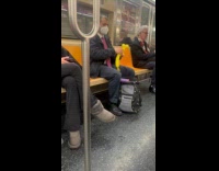 Man make balloon dog in subway train