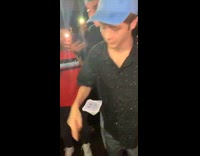 Guy makes card spin in air at party