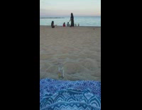 Woman in black dress walks on sand for photos 