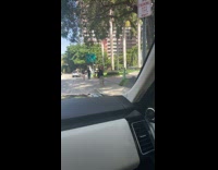 Woman walking on sidewalk with one slipper 