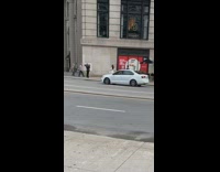 Woman white dress swirls with skirt sidewalk
