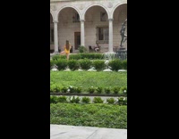 Woman yellow onesie yoga pose garden fountain