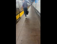 Man sleep beside fence on subway platform