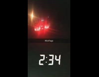 man in white lays on top of car as it drives away