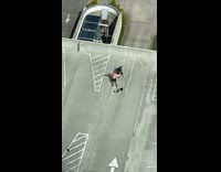 Man shirtless exercise with stretch band on the rooftop parking lot Part 2