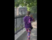 Woman walks while hitting herself with utensils